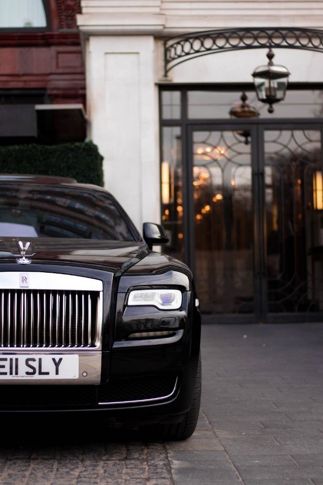 A black sleek Rolls Royce, symbolizing elegance, awaits your journey of peace and lavishness with our luxury chauffeur services in Stouffville, Toronto.